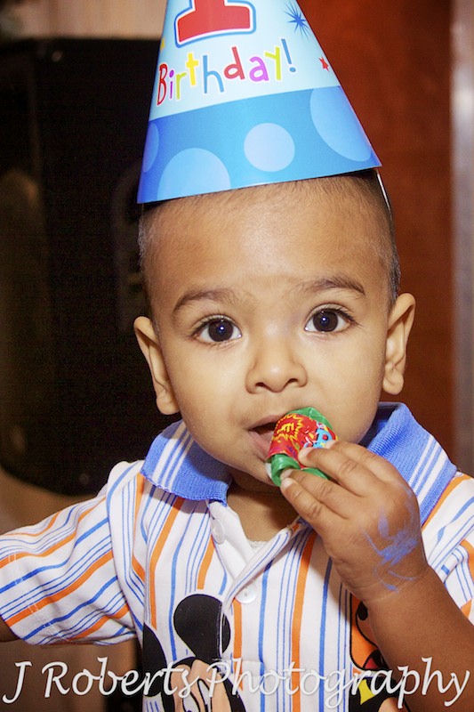 Little boy with party hat on at first birthday party - party photography sydney